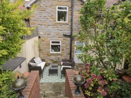 A garden with seating area and plants at 21 High Street Scarborough