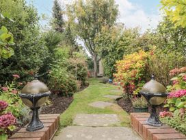 A garden with a pathway and planters at 21 High Street Scarborough