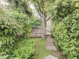 A garden pathway with hedges and a tree at 21 High Street Scarborough