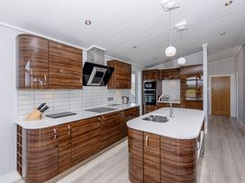 A kitchen with cabinets and an island at Wordsworth in Wigton