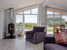 A living room with a stove and seating area at Wordsworth in Wigton