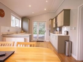 A kitchen with a dining table and modern appliances at Lawson in Wigton