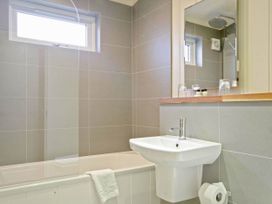 A bathroom with a bathtub, sink, and toilet at Lawson in Wigton