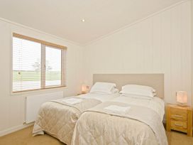 A bedroom with twin beds and a window at Lawson in Wigton