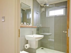 A bathroom with a sink and shower at Lawson in Wigton
