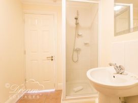 A bathroom with shower and sink at Harbourside Apartment in Weymouth
