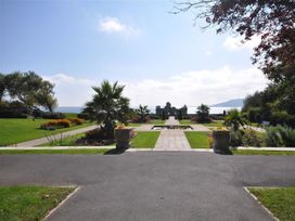 A garden with flowers and pathways at Harbourside Apartment in Weymouth