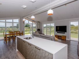 A living room with a kitchen island and dining area at Wellington in Wigton