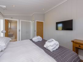 A bedroom with a bed and a television at Wellington in Wigton