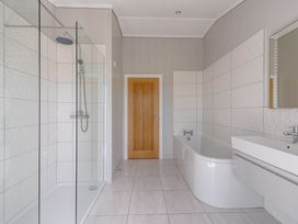 A bathroom with a shower and bathtub at Wellington in Wigton