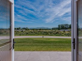 A view of greenery and mountains outside from an indoor area at Wellington in Wigton