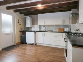 A kitchen with cabinets and appliances at 6 Berry Street, Conwy