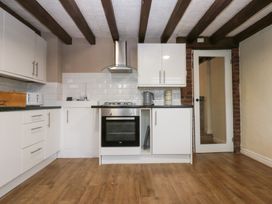 A kitchen with cabinets and appliances at 6 Berry Street in Conwy