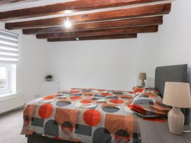 A bedroom with a bed and nightstand at 6 Berry Street in Conwy