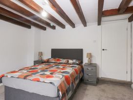 A bedroom with a bed and bedside tables at 6 Berry Street Conwy