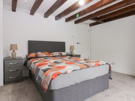 A bedroom with a bed and nightstand at 6 Berry Street in Conwy