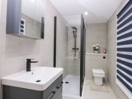 A bathroom with a shower, sink, and toilet at 6 Berry Street Conwy
