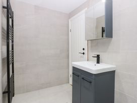 A bathroom featuring a vanity with a sink and a mirror at 6 Berry Street in Conwy