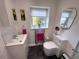 A bathroom with a sink and toilet at Ty Nain in Bodorgan