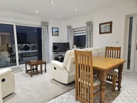 A living room with a sofa and a table at Ty Nain in Bethel