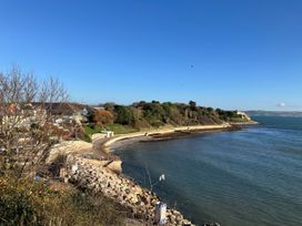 A view of the coastline with houses and trees at 12 Brewhouse Place Weymouth