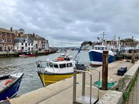 A harbor with boats and buildings at 12 Brewhouse Place Weymouth