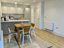 A kitchen with a table and chairs at 12 Brewhouse Place Weymouth