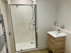 A bathroom with a shower and sink at 12 Brewhouse Place Weymouth