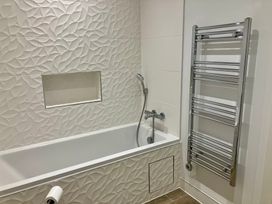 A bathroom with a bathtub and shower fittings at 12 Brewhouse Place Weymouth