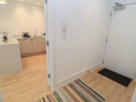 A hallway leading to a kitchen at Brewery View in Weymouth