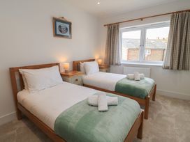 A bedroom with two single beds and a window at Brewery View in Weymouth