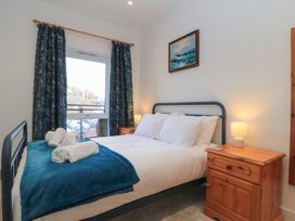 A bedroom with a bed and bedside table at Brewery View in Weymouth
