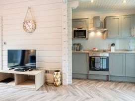 A kitchen with a TV stand and appliances at Askrigg (Pet) Aysgarth