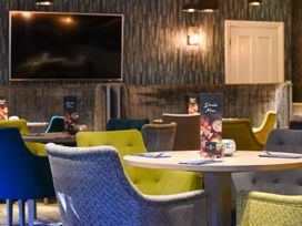 A dining room with tables and chairs at Askrigg (Pet) Aysgarth