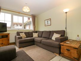 A living room with a sofa and television at Dovecote Cottage Corse near Gloucester