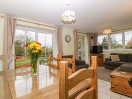 A dining room with a table and chairs at Dovecote Cottage in Corse near Gloucester
