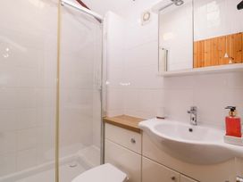 A bathroom with shower and sink at The Log Cabin Corse near Gloucester