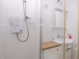 A bathroom with a shower and sink at The Log Cabin in Corse near Gloucester