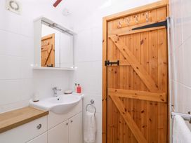 A bathroom with a sink and mirror at The Log Cabin in Corse near Gloucester
