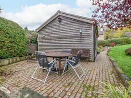 A garden with a table and chairs at The Log Cabin in Corse near Gloucester