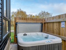 A hot tub next to a wooden fence at Somersby Spa in Louth