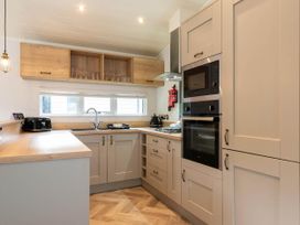 A kitchen with cabinets and appliances at Wensleydale in Aysgarth