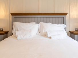 A bed with pillows and towels in a bedroom at Wensleydale Aysgarth