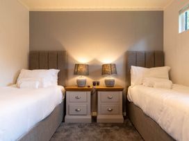 A bedroom with two single beds and nightstands at Wensleydale Aysgarth