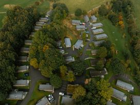 An aerial view of a group of cabins in a forested area at Wensleydale Aysgarth