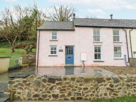 A house with blue door and stone wall at Fronglyd Aberporth