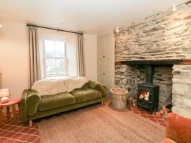 A living room with a fireplace and sofa at Fronglyd Aberporth