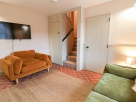A living room with a sofa and television at Fronglyd in Aberporth