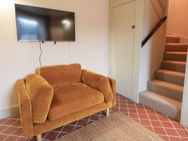 A living room with a sofa and television at Fronglyd in Aberporth