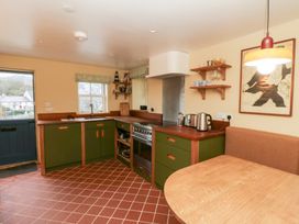 A kitchen with a stove and sink at Fronglyd Aberporth